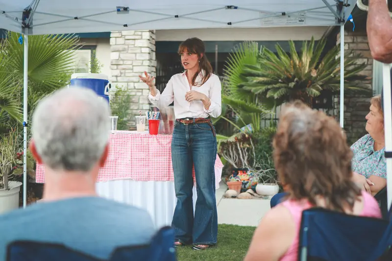 Kathryn Halling speaking to neighbors at a front-yard meet-and-greet